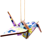 Wooden origami crane ornament featuring purple, blue, and green pansies with metallic gold accents.