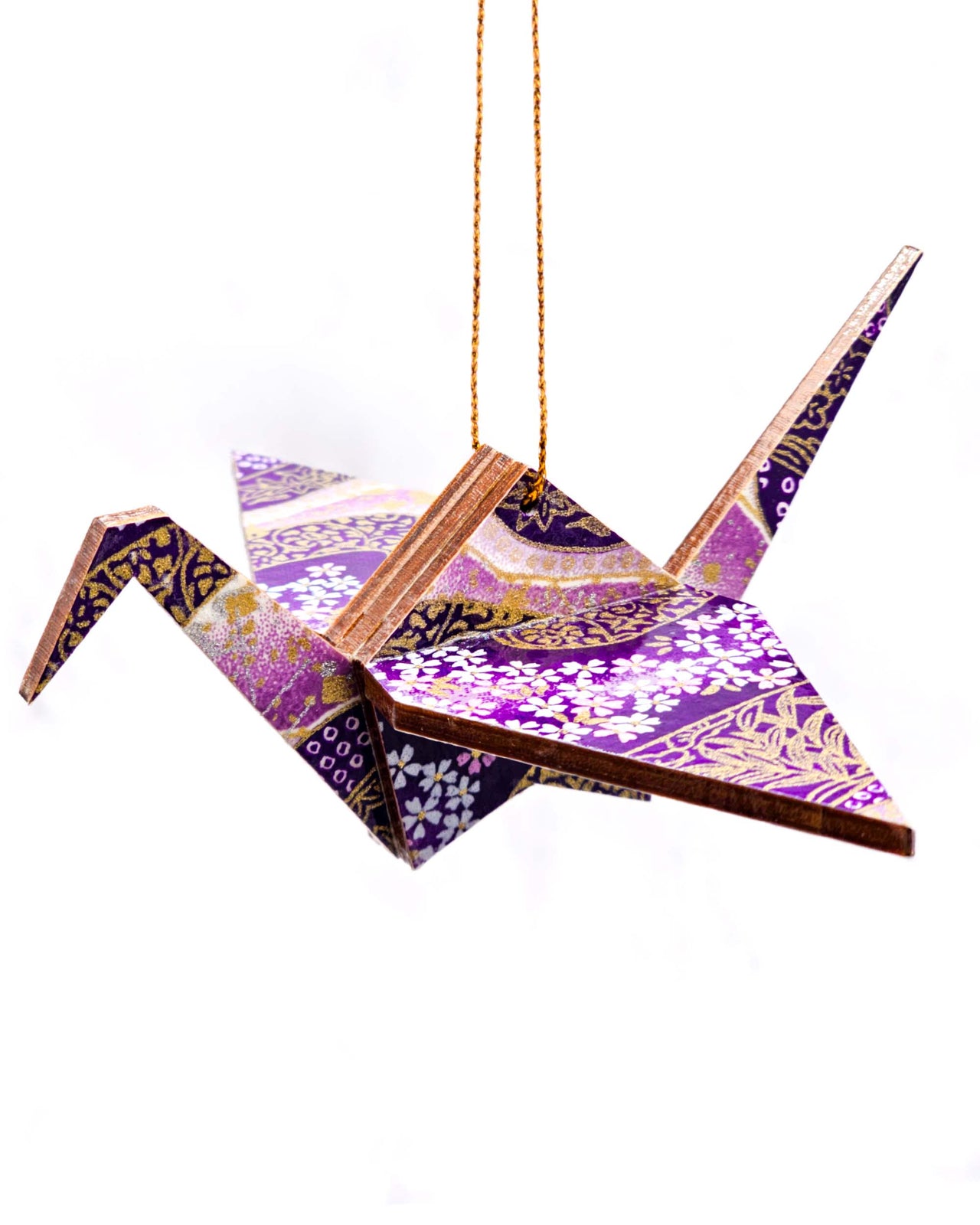 Wooden origami crane ornament featuring small purple and white cherry blossoms on a purple and white background with metallic gold accents.