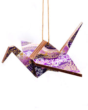 Wooden origami crane ornament featuring small purple and white cherry blossoms on a purple and white background with metallic gold accents.