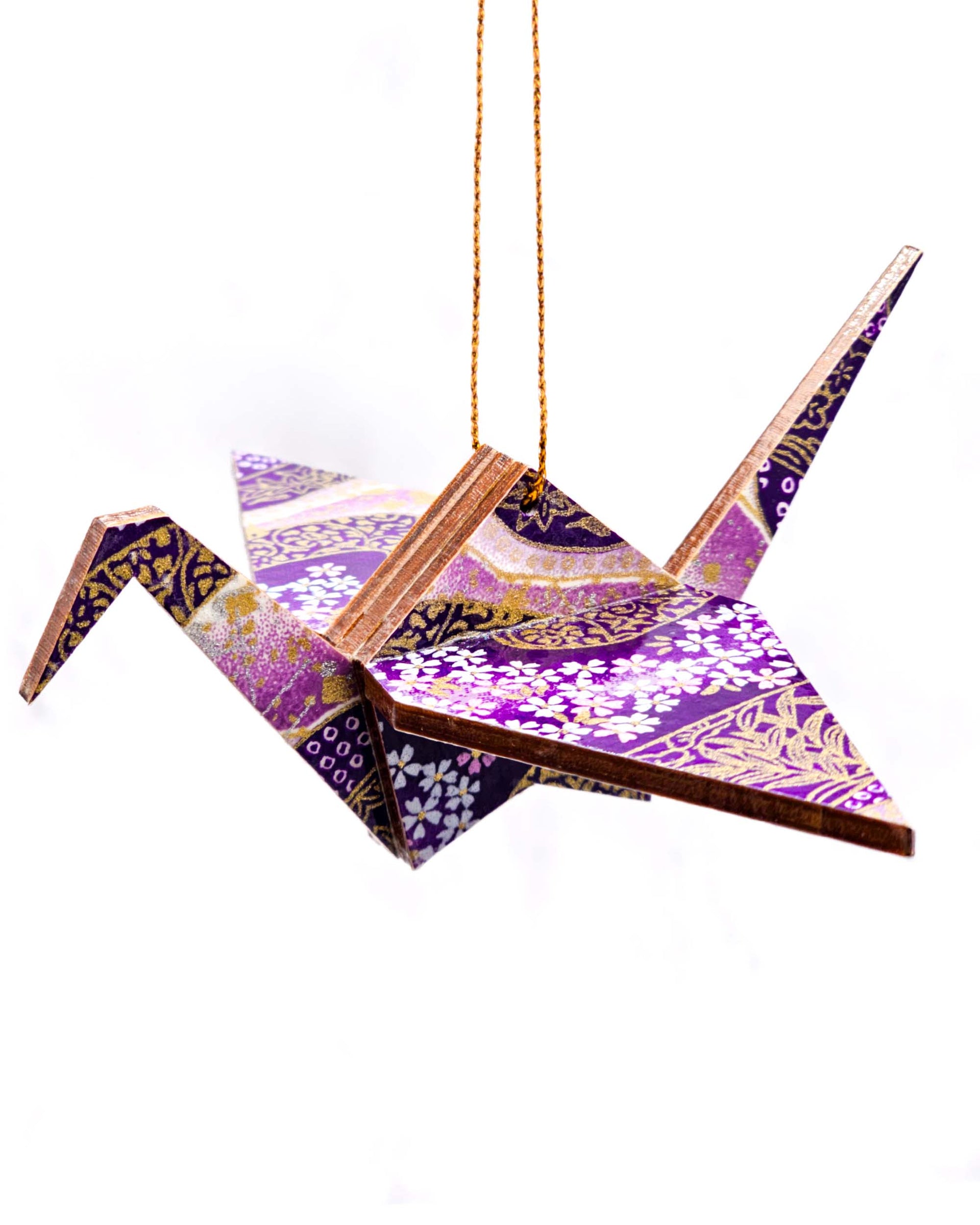 Wooden origami crane ornament featuring small purple and white cherry blossoms on a purple and white background with metallic gold accents.