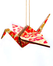 Wooden origami crane ornament featuring red cherry blossoms on a brown background with metallic gold accents.