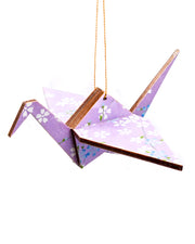 Wooden origami crane ornament featuring white and blue cherry blossoms on a light purple background.