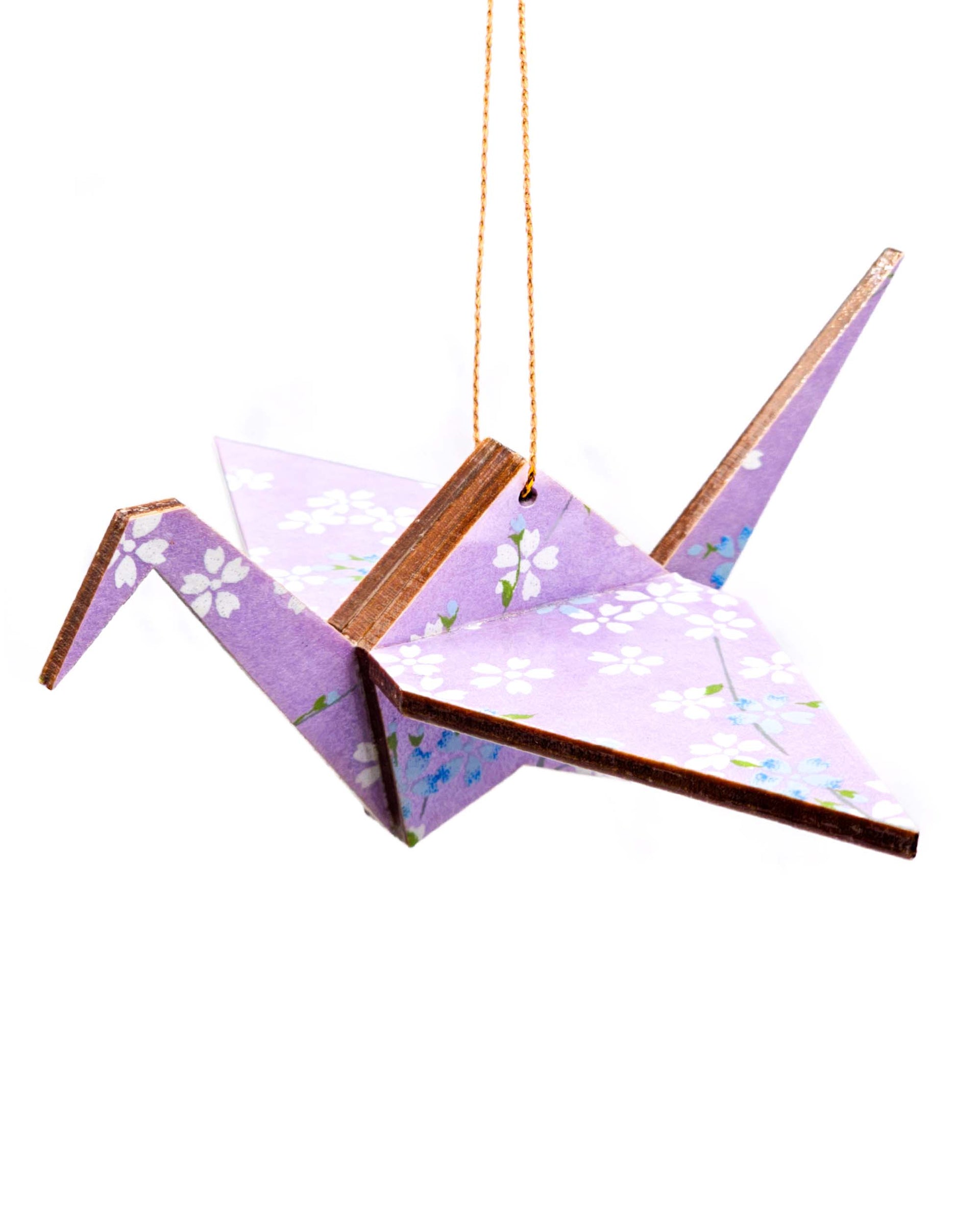 Wooden origami crane ornament featuring white and blue cherry blossoms on a light purple background.