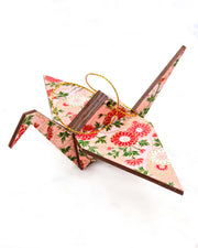 Large wooden origami crane ornament featuring pink, white, and red chrysanthemums with green leaves on a pink background with metallic gold accents.