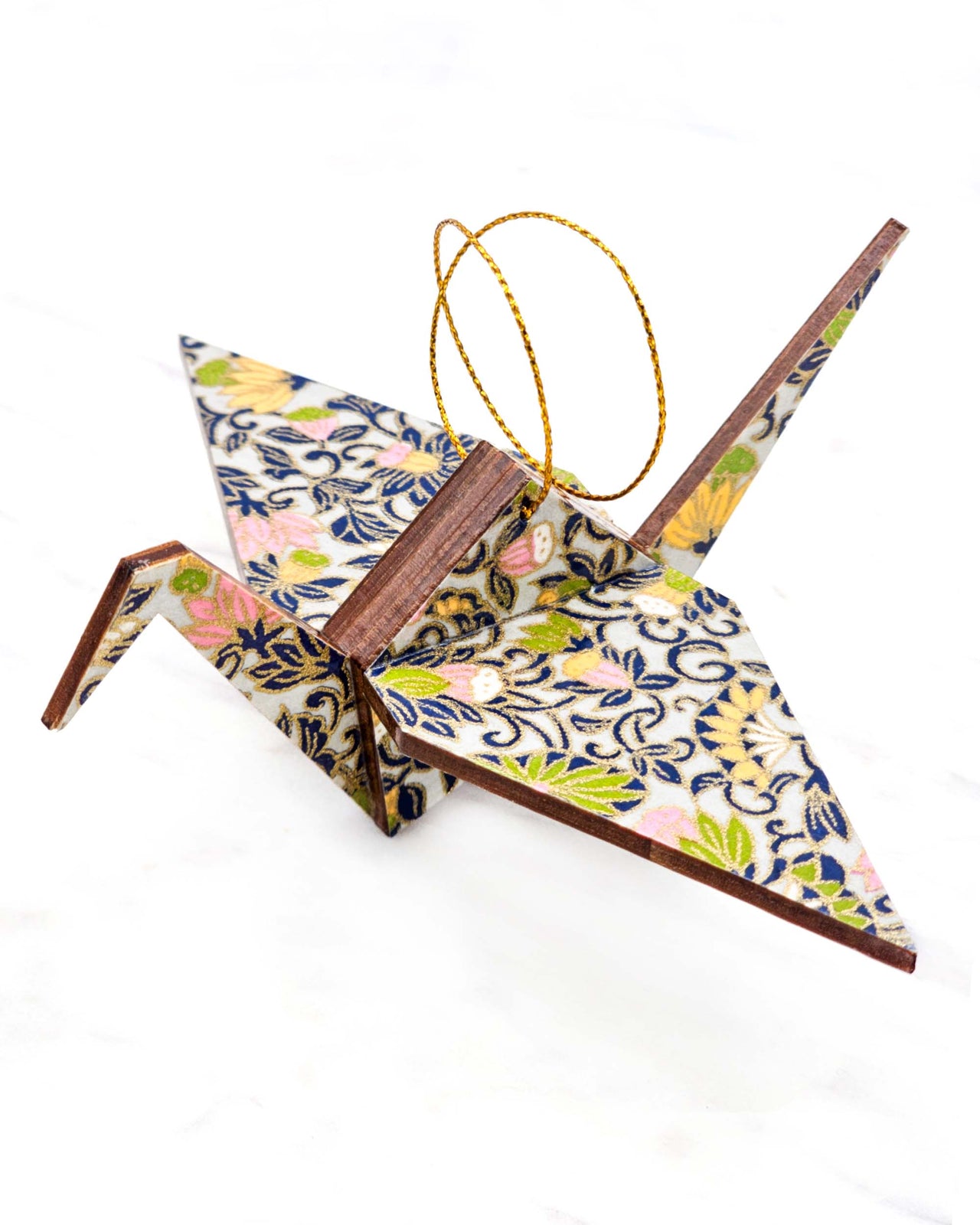 Large wooden origami crane ornament featuring yellow, pink, and green daffodil flowers on a gray background with metallic gold details.