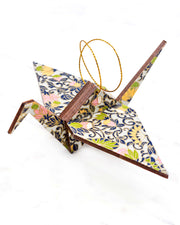 Large wooden origami crane ornament featuring yellow, pink, and green daffodil flowers on a gray background with metallic gold details.