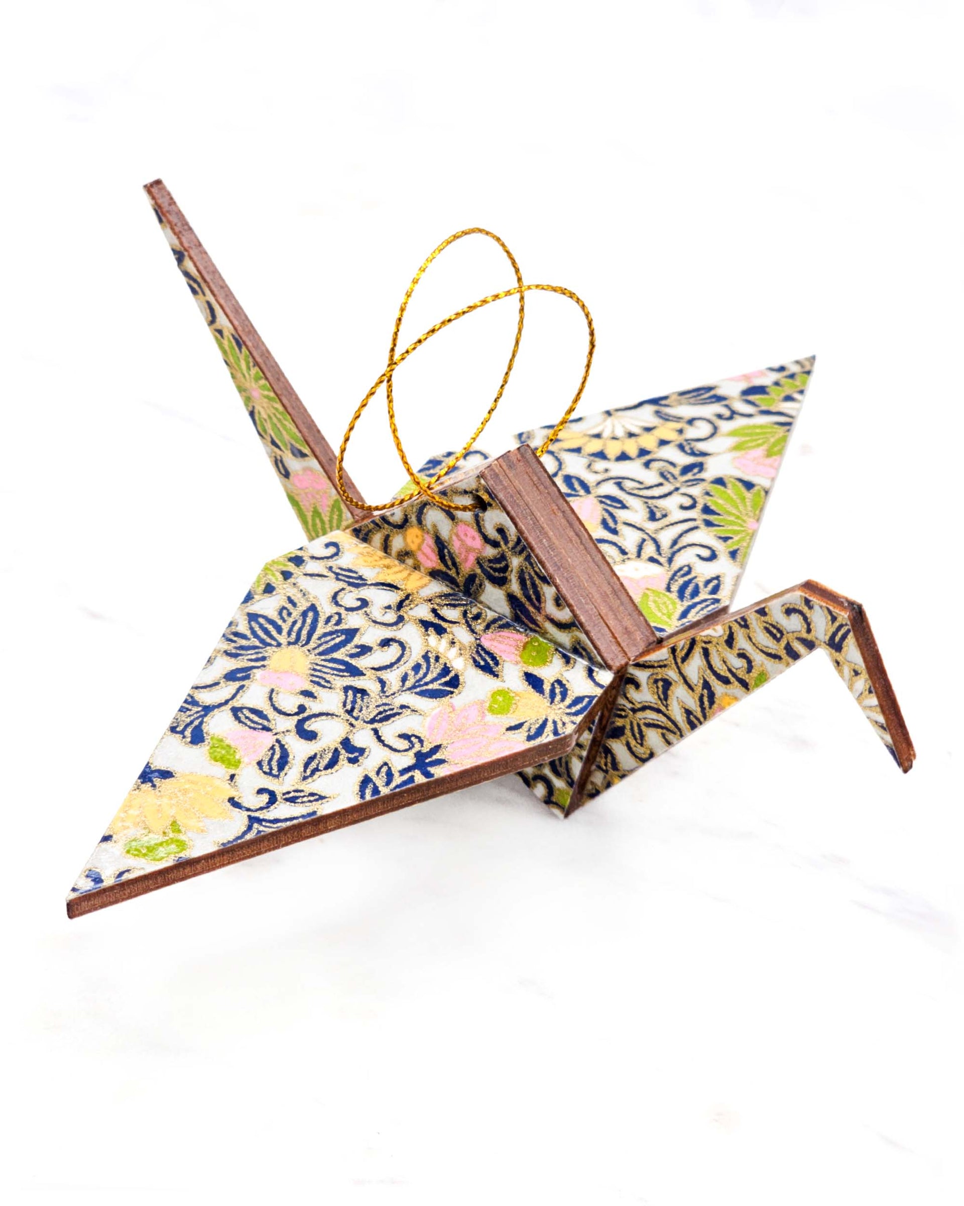 Large wooden origami crane ornament featuring yellow, pink, and green daffodil flowers on a gray background with metallic gold details.