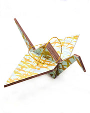 Large wooden origami crane ornament featuring small flying gold and silver cranes on a turquoise background with metallic gold details.