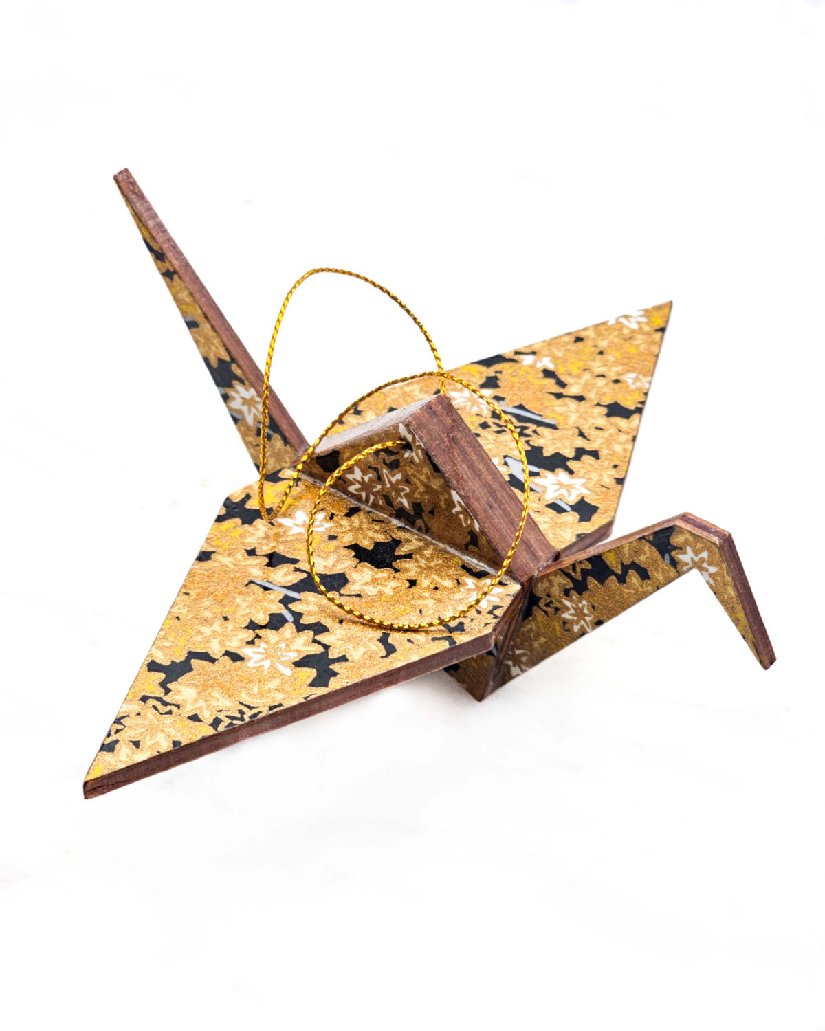 Large wooden origami crane ornament featuring small metallic gold and white momiji (maple leaves) on a black background.