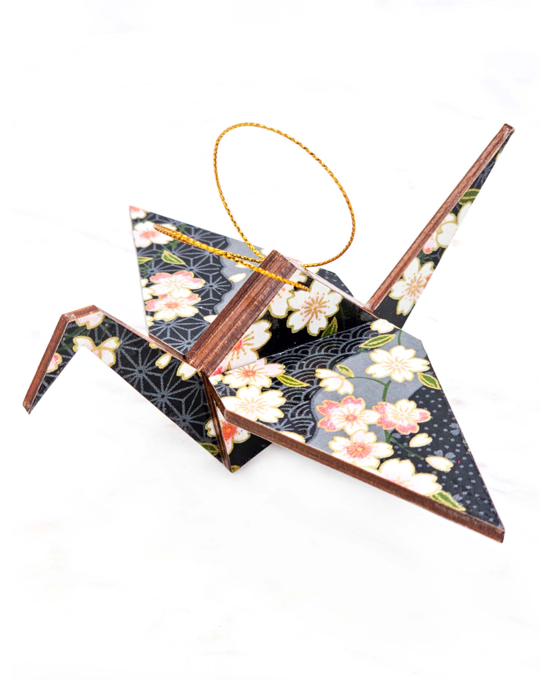 Large wooden origami crane ornament featuring pink and white cherry blossoms on a black and gray background with metallic gold accents.