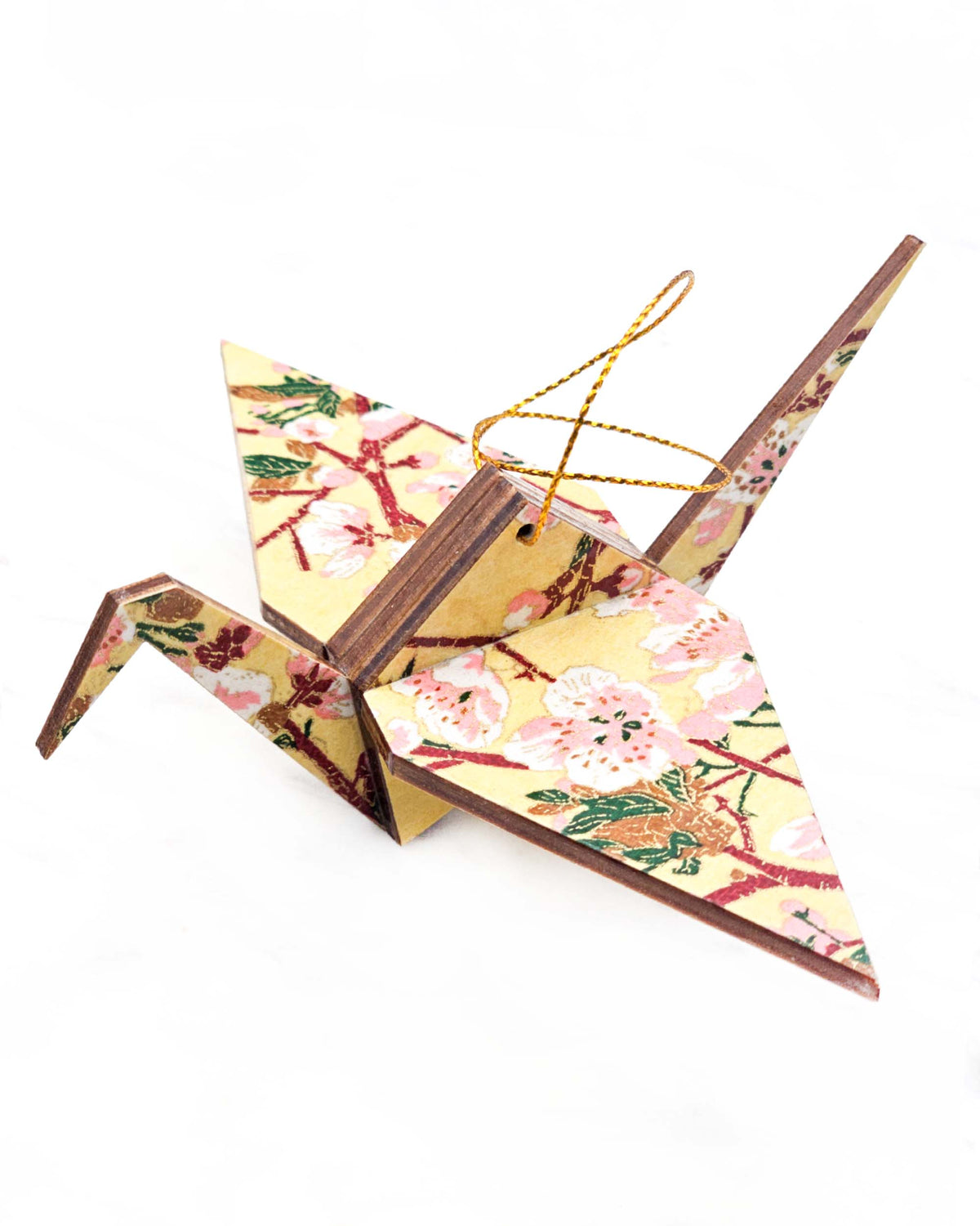 Large wooden origami crane ornament featuring pink and white plum blossoms with dark brown branches and green leaves on a beige background with metallic gold details.