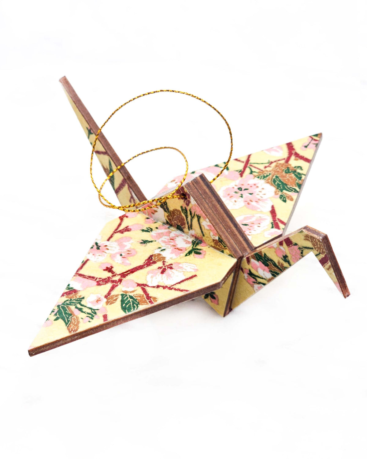 Large wooden origami crane ornament featuring pink and white plum blossoms with dark brown branches and green leaves on a beige background with metallic gold details.