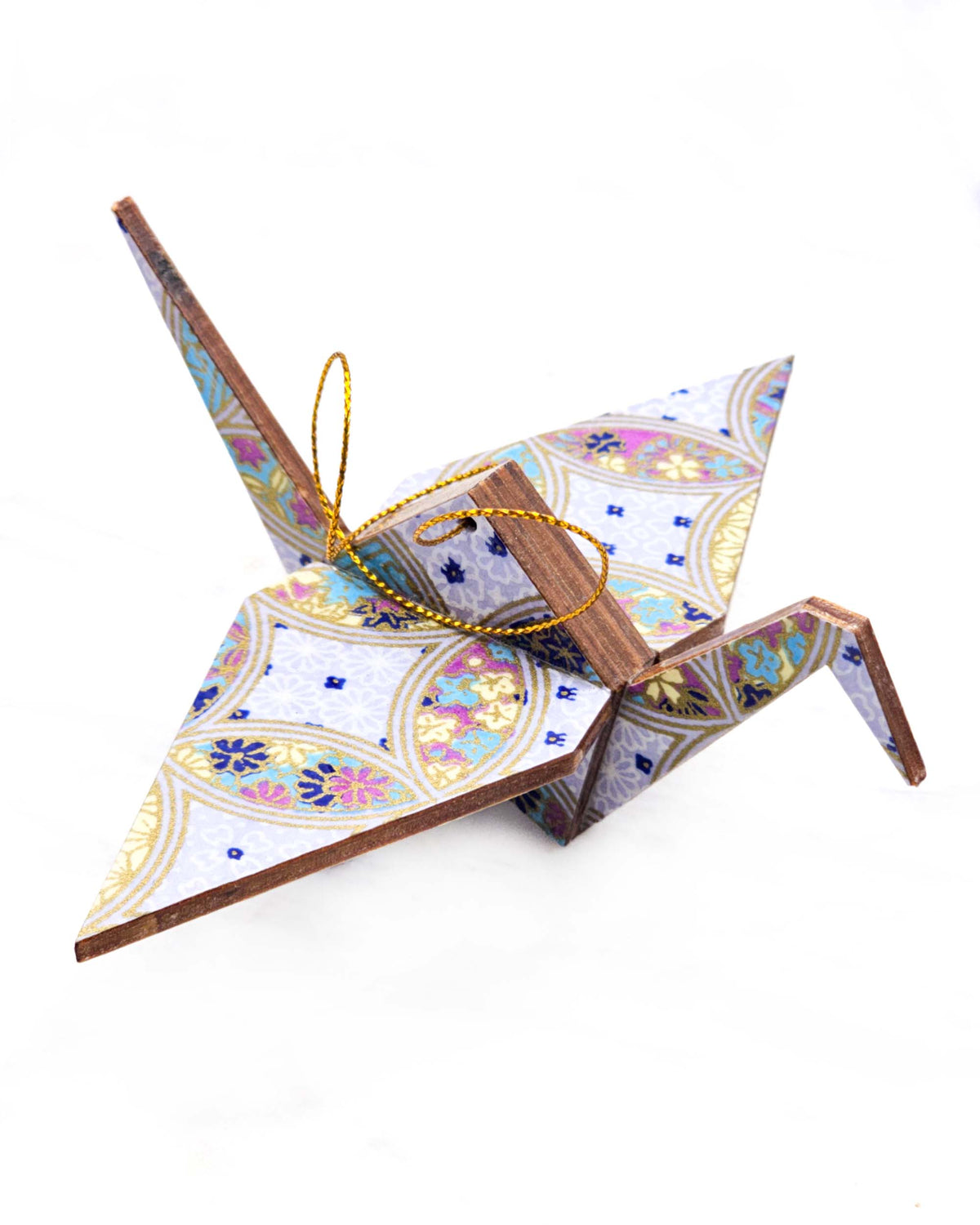 Large wooden origami crane ornament featuring a blue, yellow, and purple shippo design filled with assorted floral and geometric designs on a light purple background with metallic gold details.