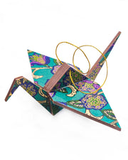 Large wooden origami crane ornament featuring purple and blue sarasa flowers on a pearlescent green background with metallic gold details.