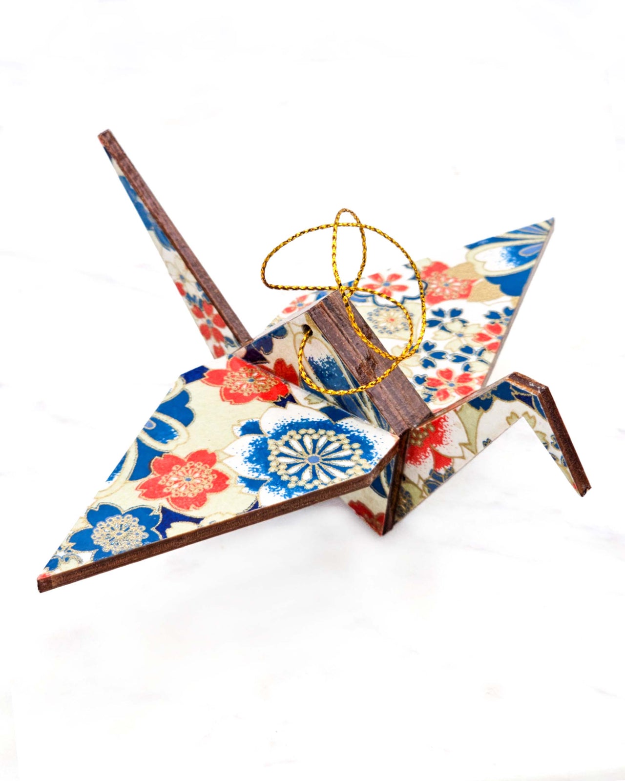 Large wooden origami crane ornament featuring red, white, and blue cherry blossoms with metallic gold details.