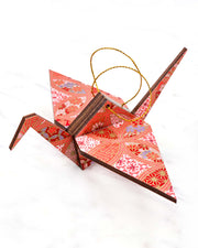 Large wooden origami crane ornament featuring a red, pink, and purple shippo design filled with assorted floral and geometric designs with metallic gold details. The centers of the shippos features assorted white floral outlines.