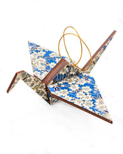 Large wooden origami crane ornament featuring white cherry blossoms on a blue background with metallic gold accents.