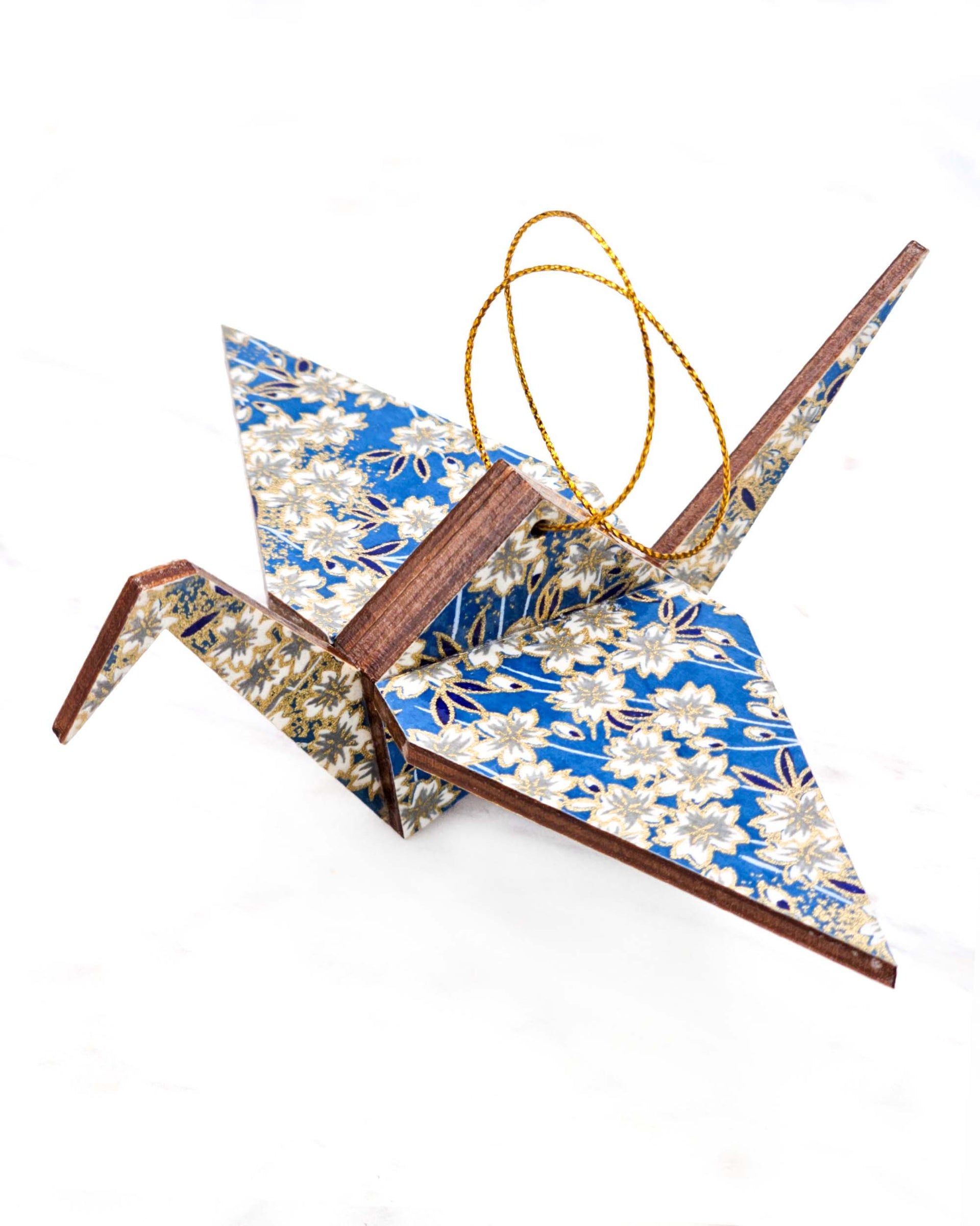Large wooden origami crane ornament featuring white cherry blossoms on a blue background with metallic gold accents.