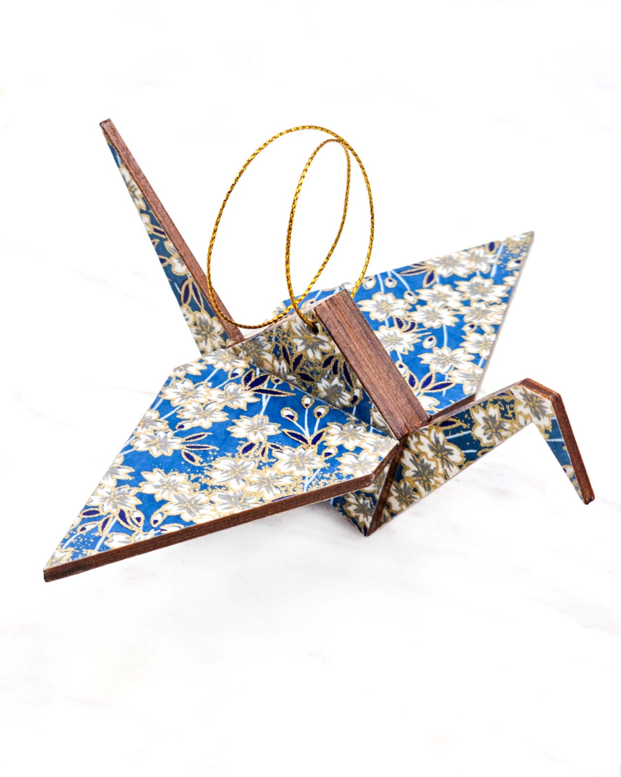 Large wooden origami crane ornament featuring white cherry blossoms on a blue background with metallic gold accents.