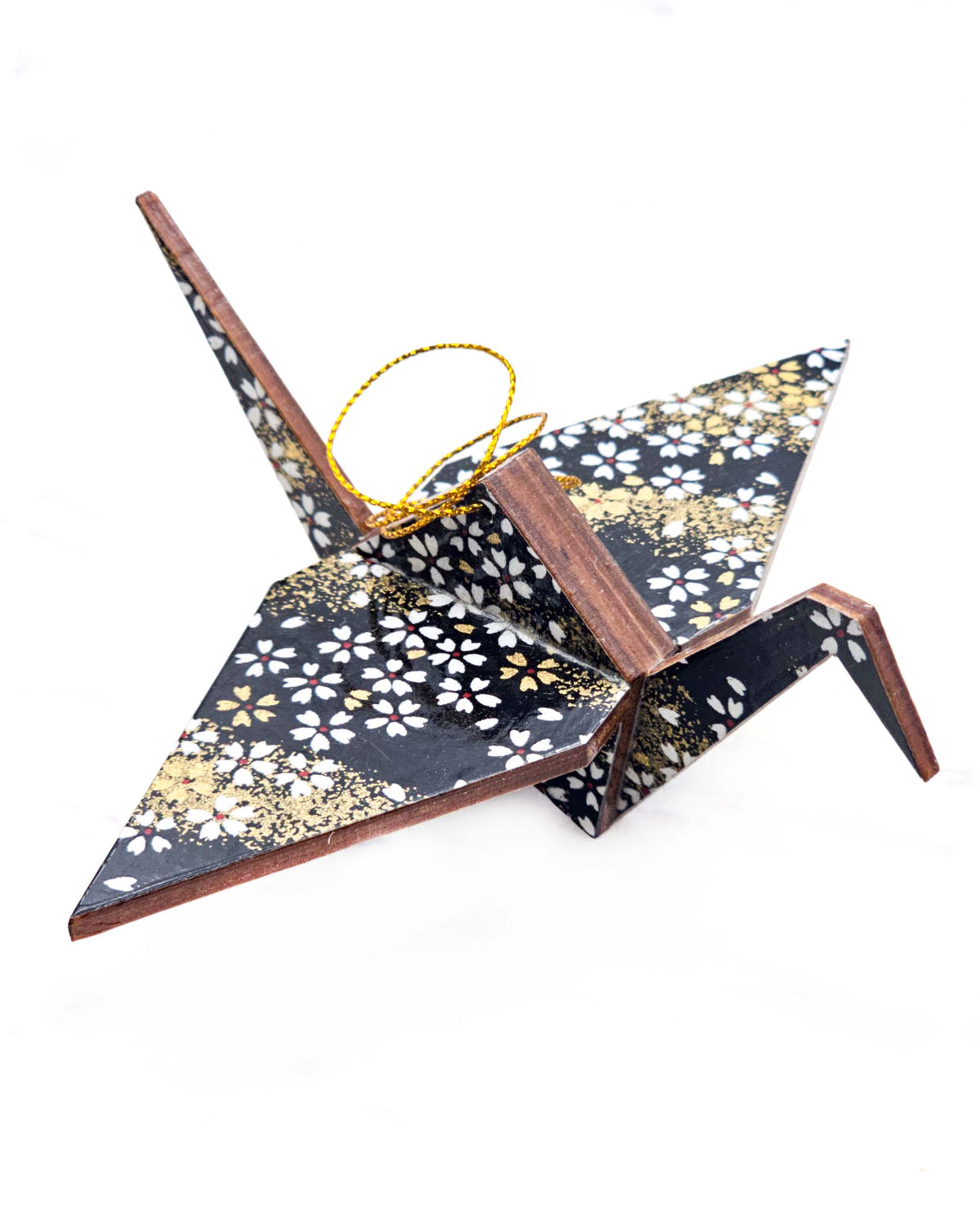 Large wooden origami crane ornament featuring small white and gold cherry blossoms on a black background with metallic gold details.