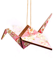 Wooden origami crane ornament featuring pink and white cherry blossoms on a light pink background with metallic gold accents.
