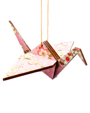 Wooden origami crane ornament featuring pink and white cherry blossoms on a light pink background with metallic gold accents.