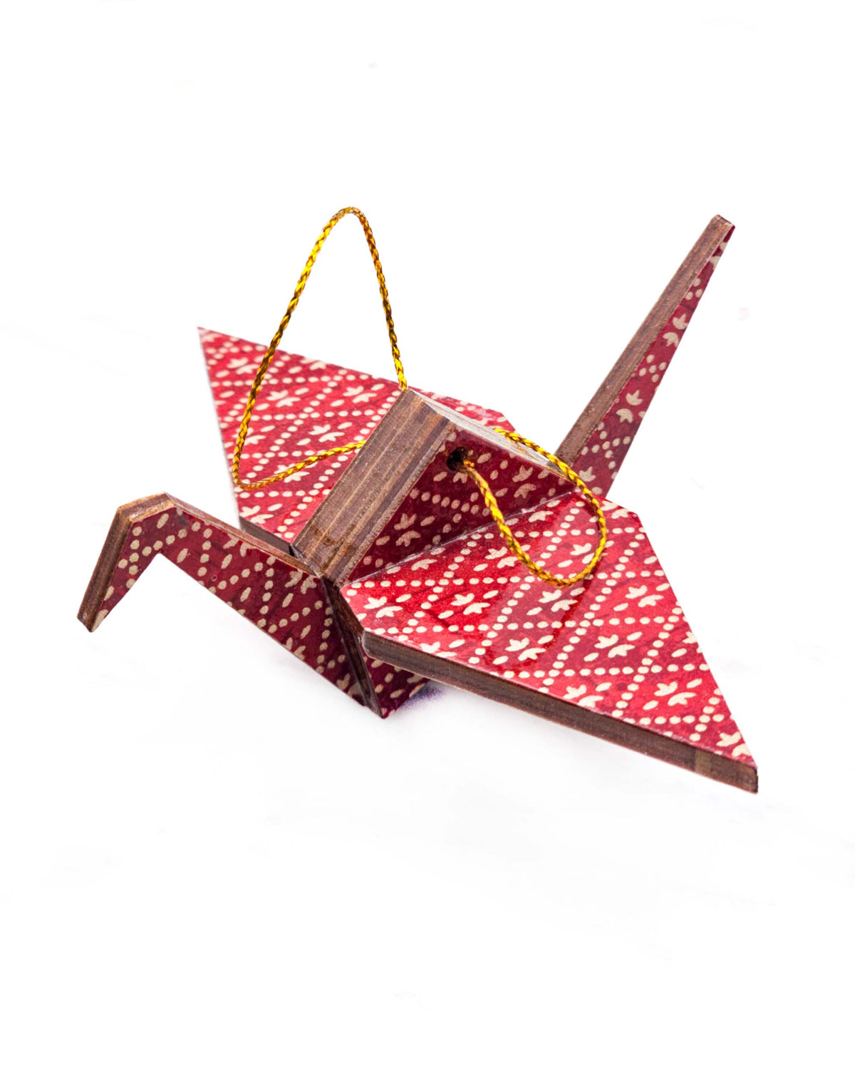 Small wooden origami crane ornament featuring a gold hishi (diamond) design on a patchy red background.