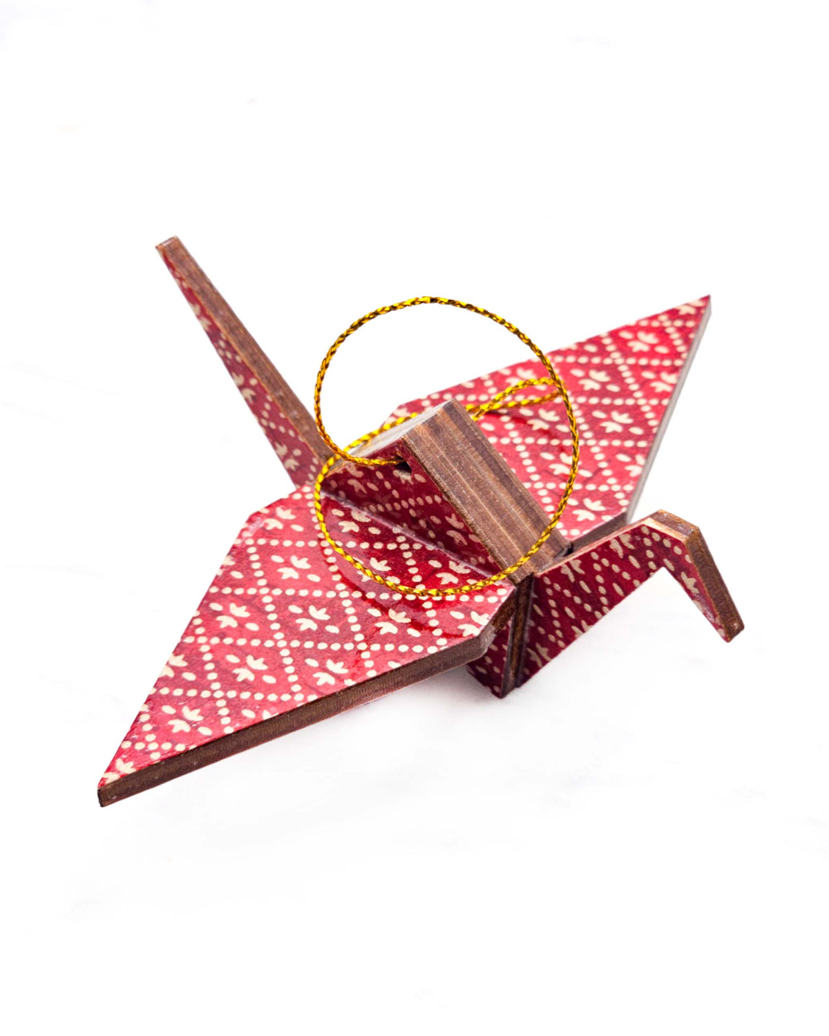 Small wooden origami crane ornament featuring a gold hishi (diamond) design on a patchy red background.