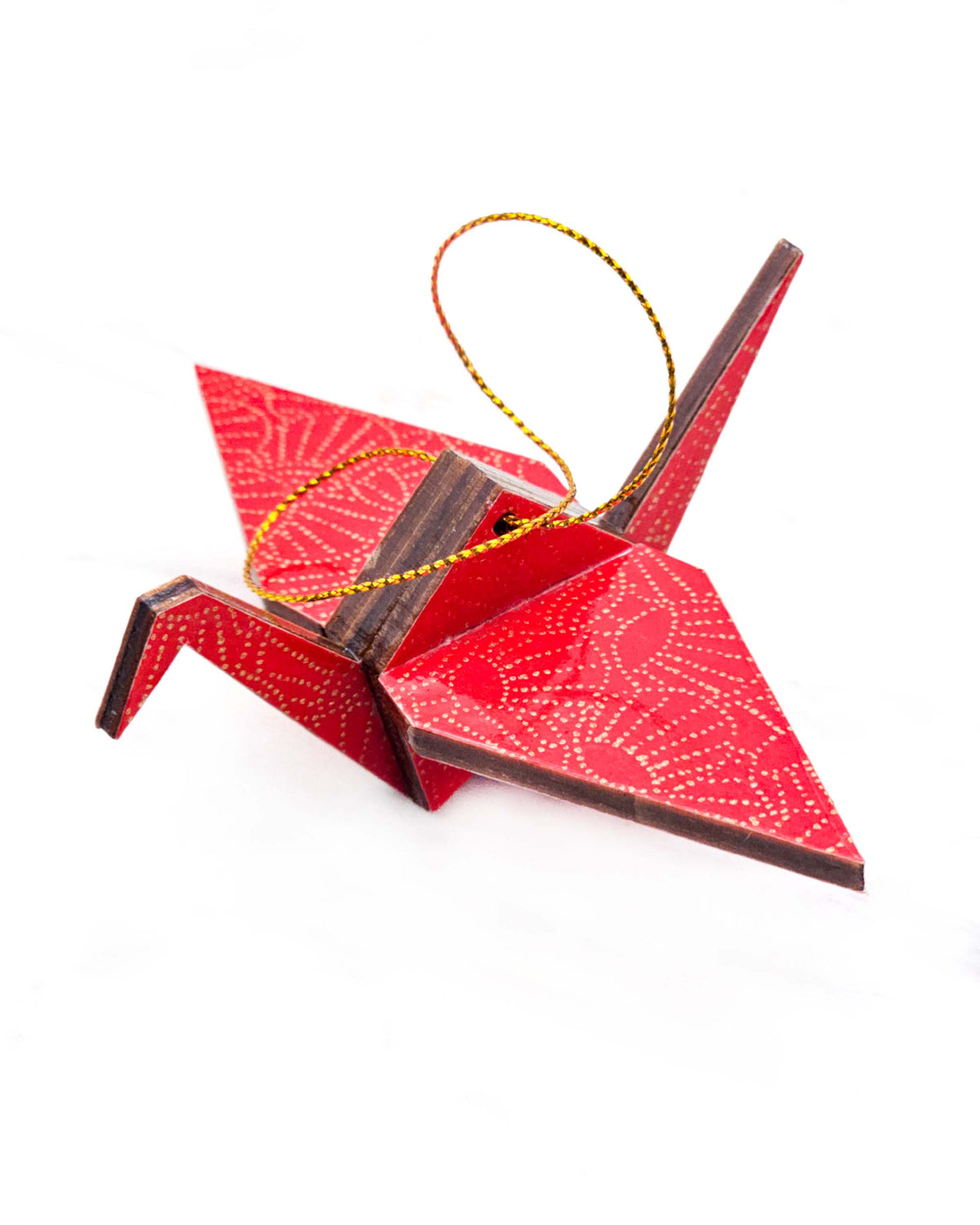 Small wooden origami crane ornament featuring metallic gold pointillistic temari balls on a red background.