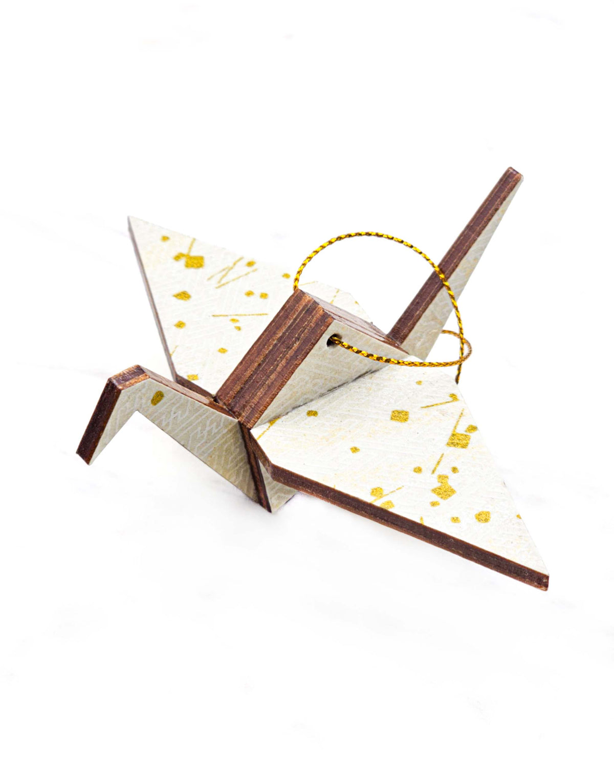 Small wooden origami crane ornament featuring a white traditional Japanese sayagata design on a white background with metallic gold details.