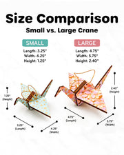 A size comparison display of the small and large wooden origami crane ornaments.