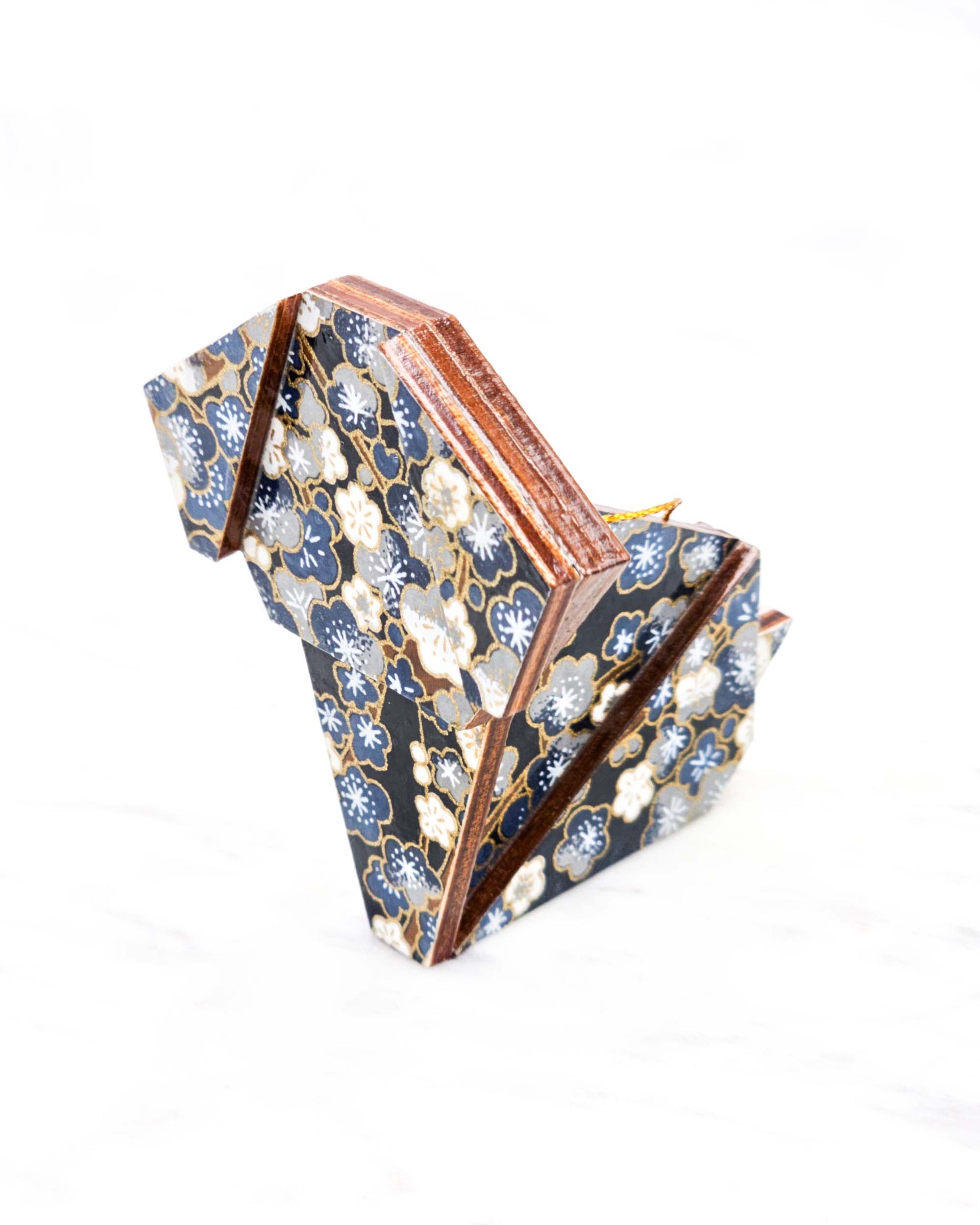 Large wooden origami dog ornament featuring blue and gray plum blossom trees with brown branches on a dark blue background with metallic gold details.
