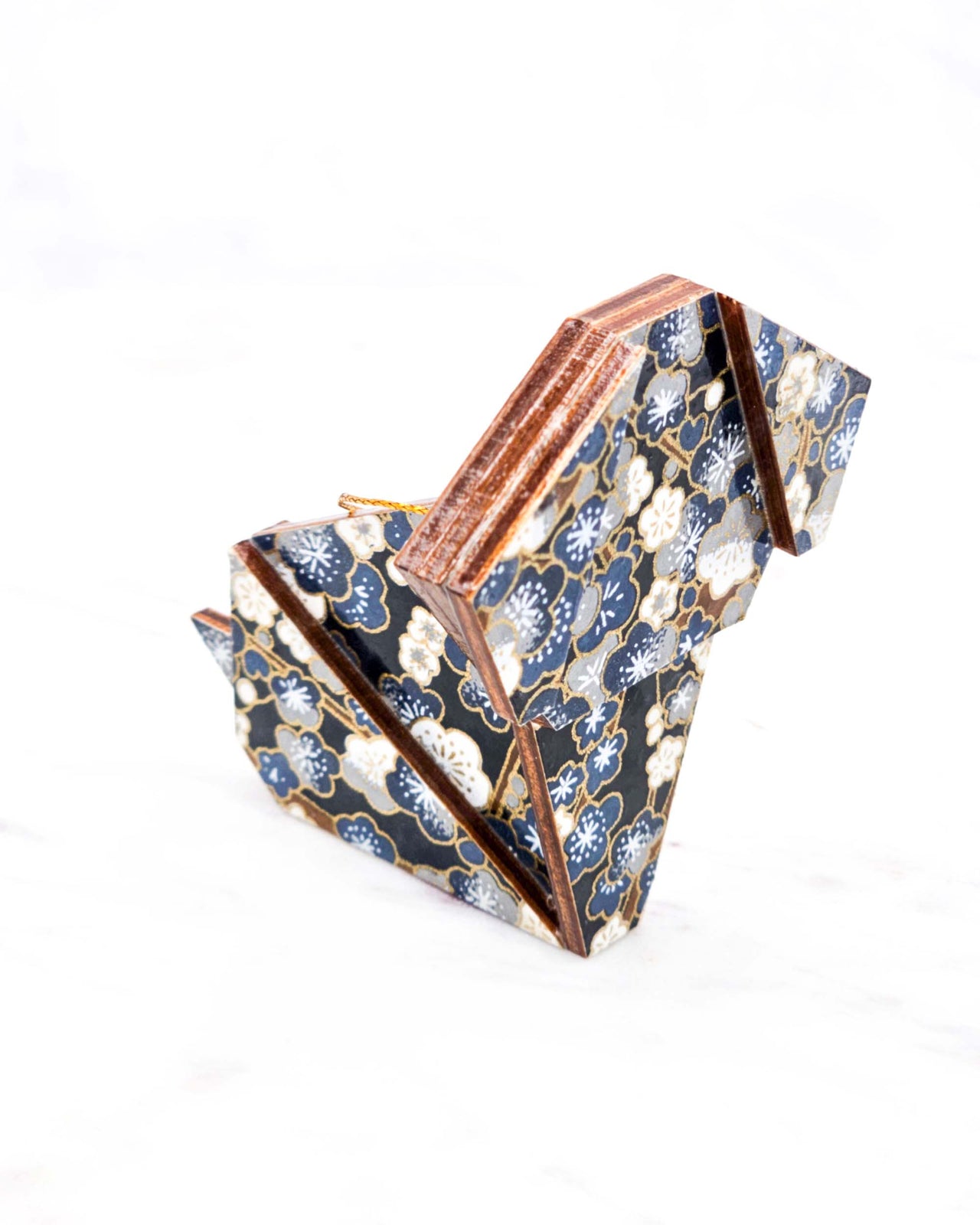 Large wooden origami dog ornament featuring blue and gray plum blossom trees with brown branches on a dark blue background with metallic gold details.

