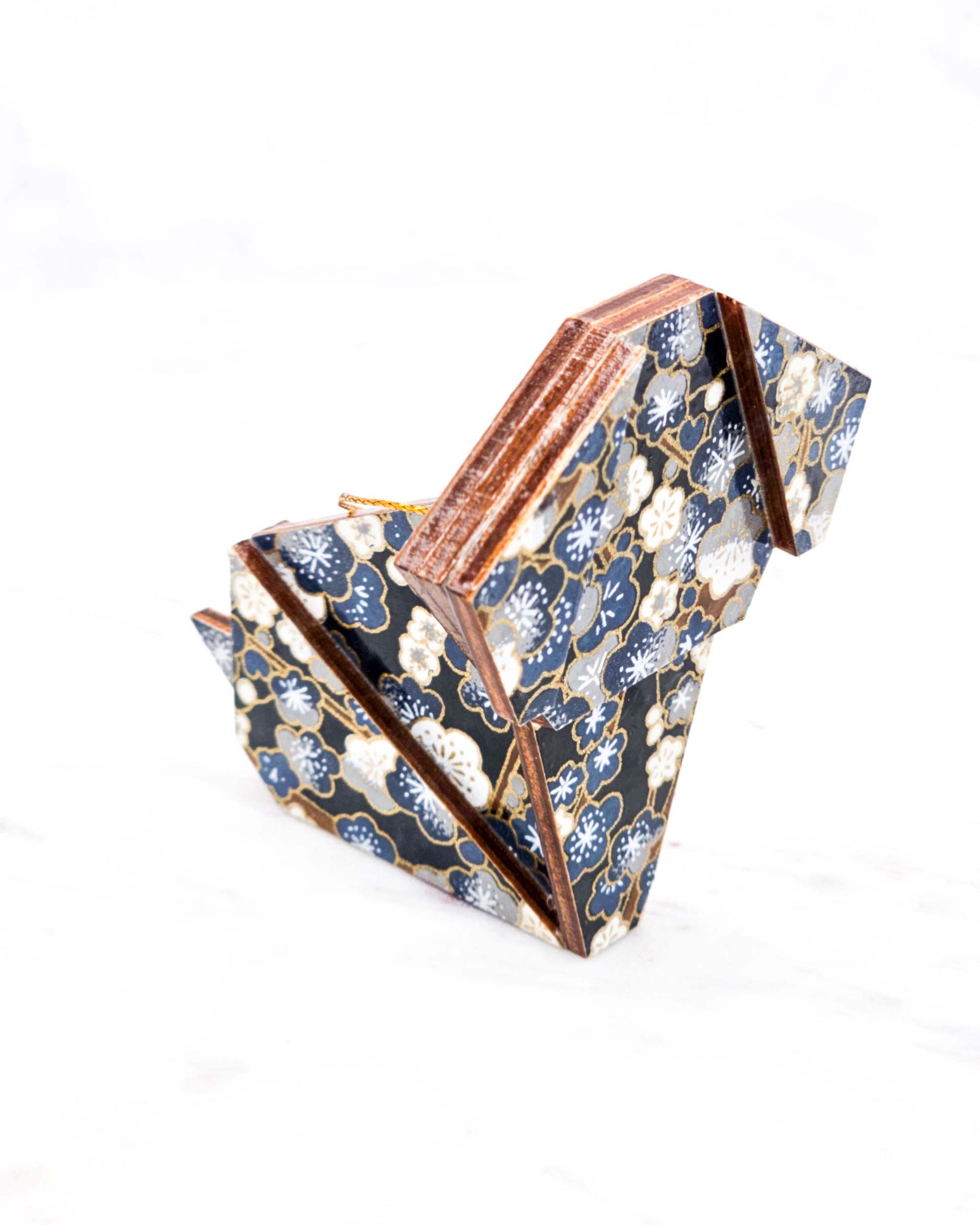 Large wooden origami dog ornament featuring blue and gray plum blossom trees with brown branches on a dark blue background with metallic gold details.

