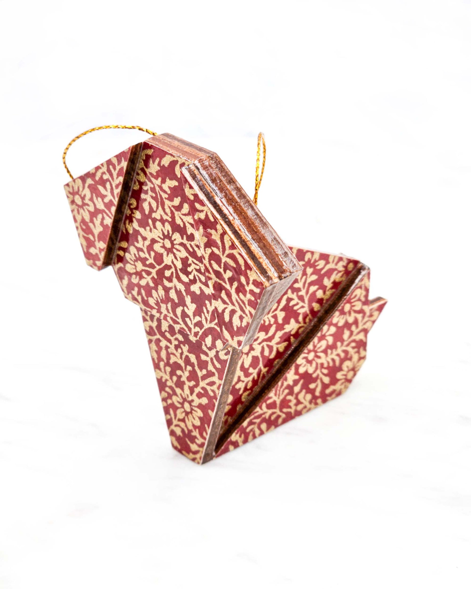 Large wooden origami dog ornament featuring a metallic gold floral motif on a red background.