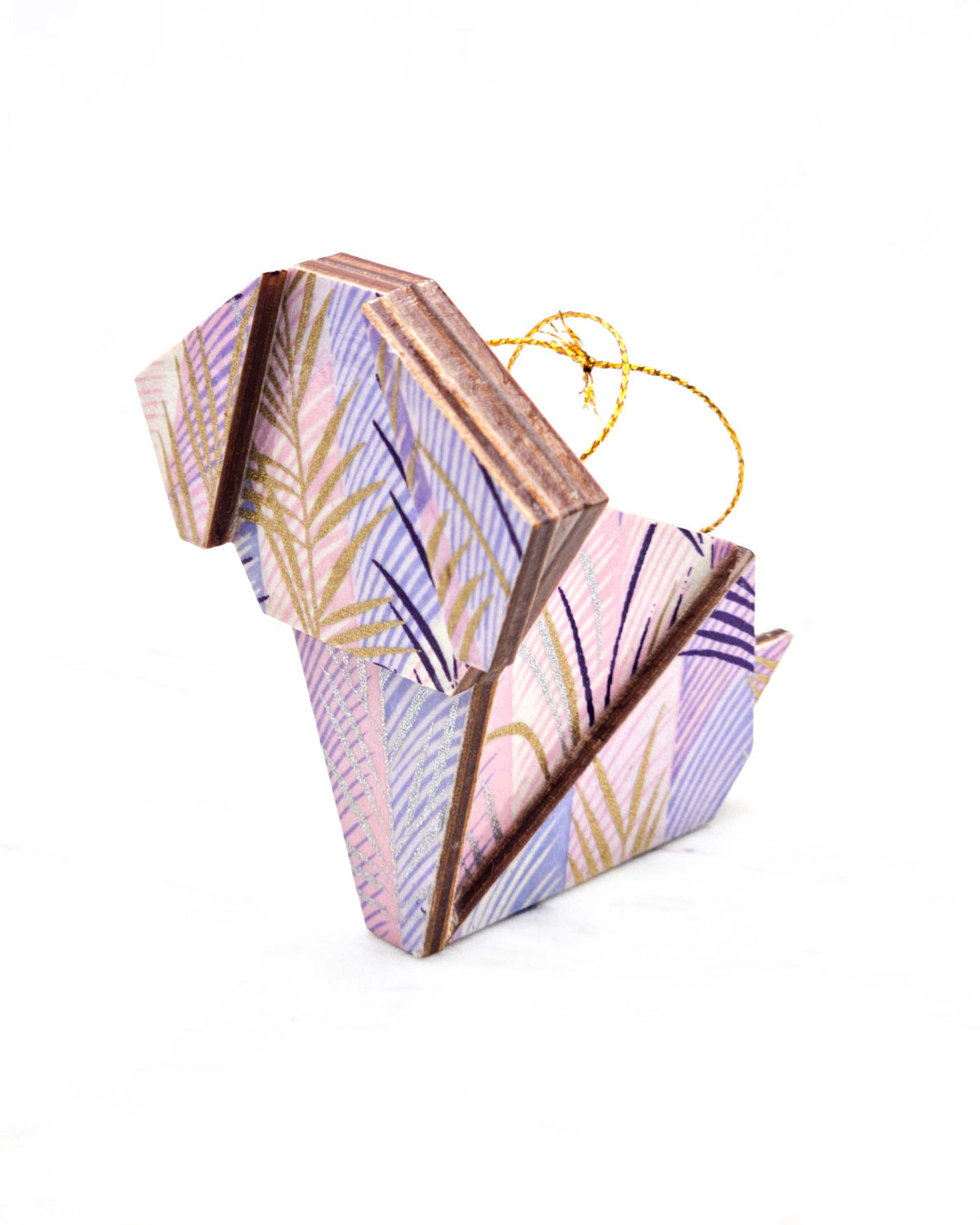 Large wooden origami dog ornament featuring metallic gold, silver, and dark purple leaves on a vertically striped light purple background.