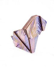 Large wooden origami dog ornament featuring metallic gold, silver, and dark purple leaves on a vertically striped light purple background.