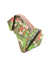 Large wooden origami dog ornament featuring a green floral meadow with white and red flowers with metallic gold details.