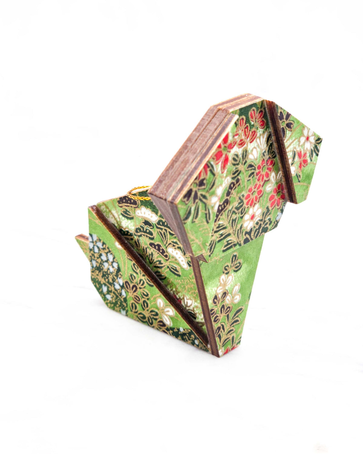 Large wooden origami dog ornament featuring a green floral meadow with white and red flowers with metallic gold details.