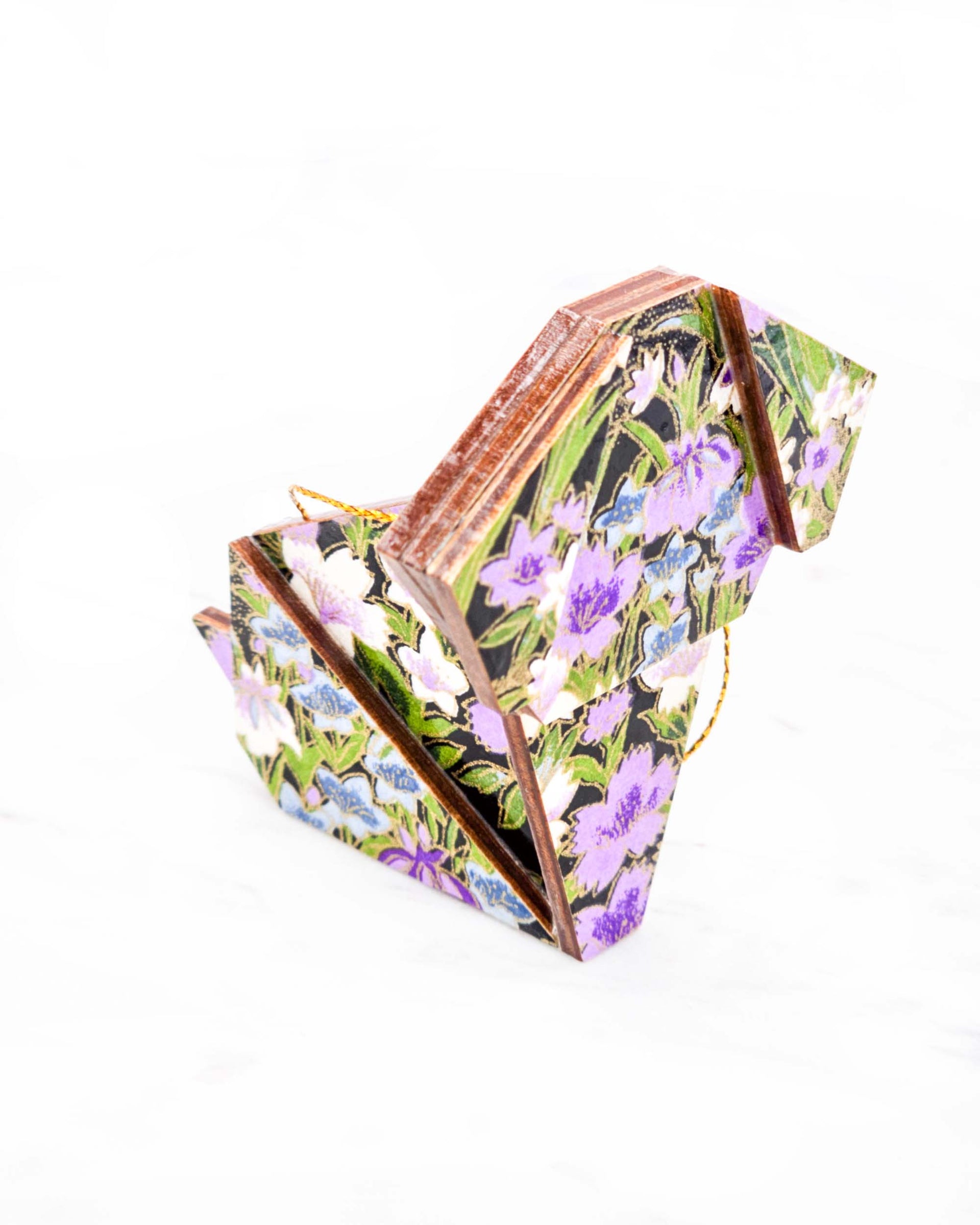 Large wooden origami dog ornament featuring blue, purple, and white irises with green stems on a black background with metallic gold details.