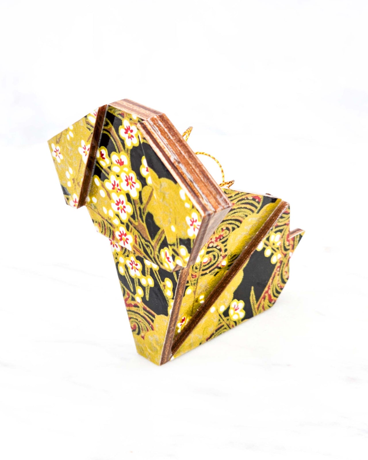 Large wooden origami dog ornament featuring small white plum blossom branches with gold and red water ripples and large gold clouds on a black background with metallic gold details.