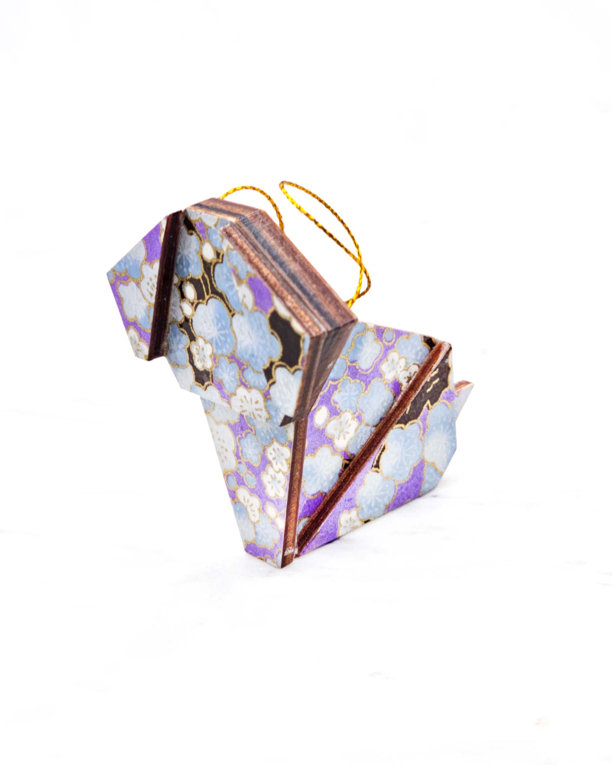 Small wooden origami dog ornament featuring light blue plum blossoms with dark brown branches on a pearlescent light purple background with metallic gold details.