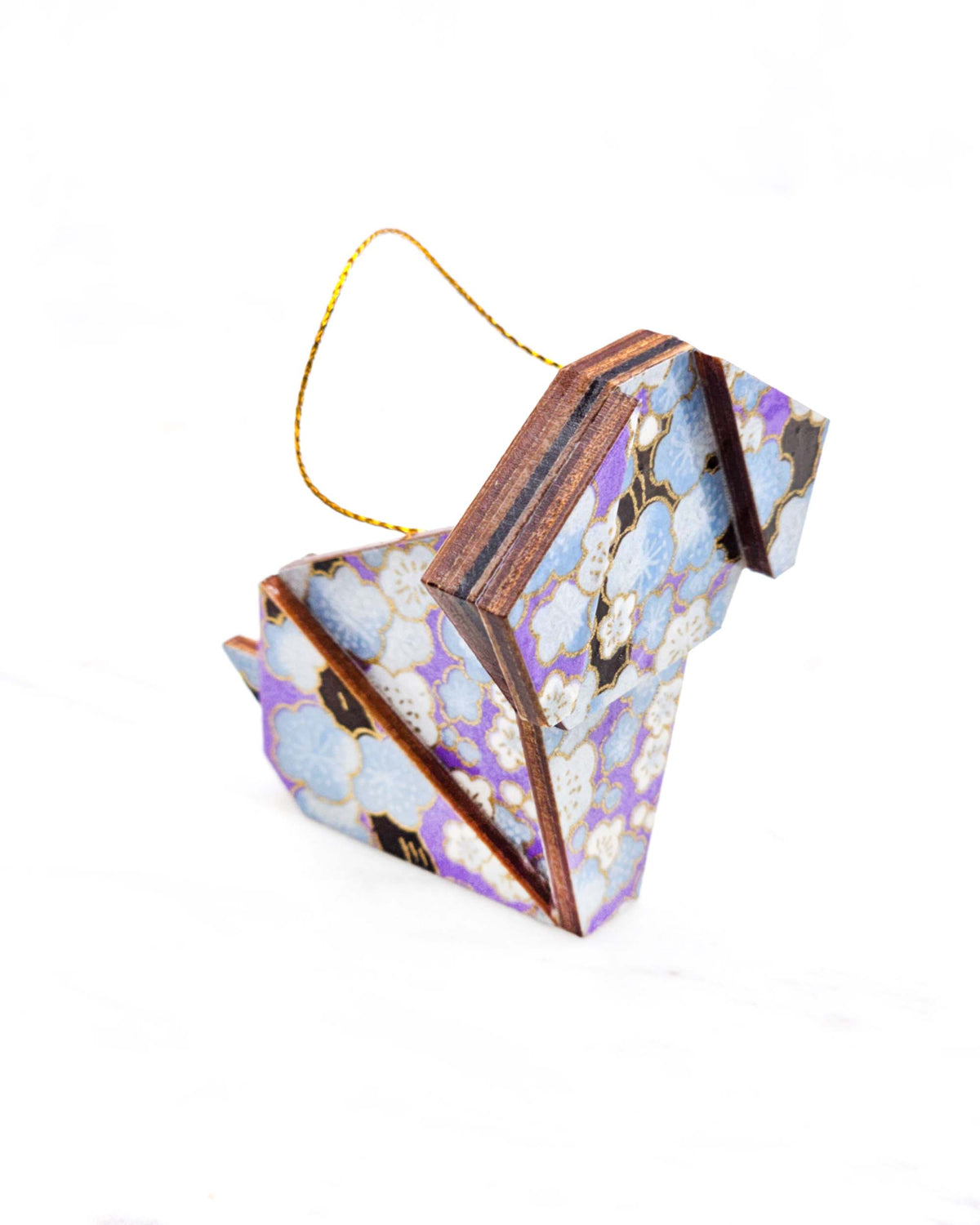 Small wooden origami dog ornament featuring light blue plum blossoms with dark brown branches on a pearlescent light purple background with metallic gold details.