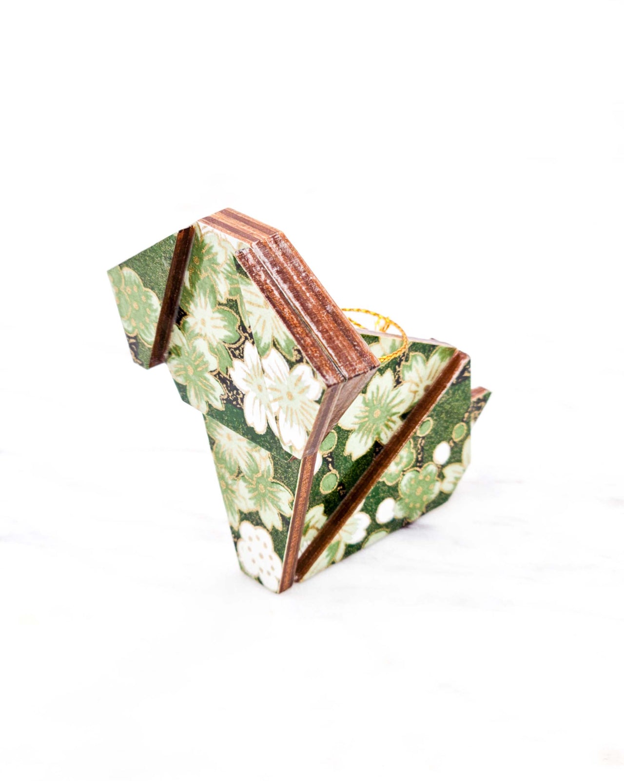 Small wooden origami dog ornament featuring green and white cherry and plum blossoms on a green background with metallic gold details.