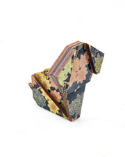 Small wooden origami dog ornament featuring assorted green, pink, beige, and gray maple leaves with dark gray and metallic gold dotted maple leaves on a dark gray background.