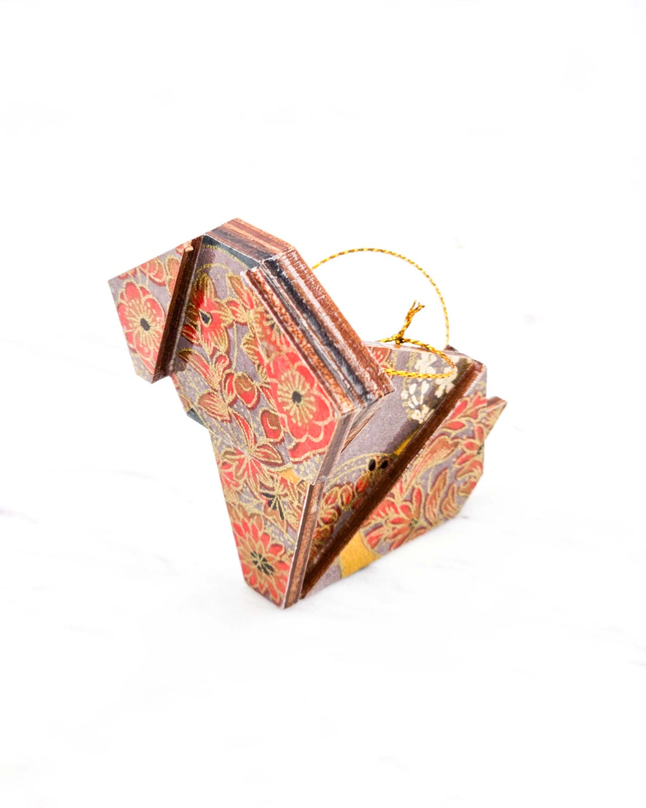 Small wooden origami dog ornament featuring orange flowers on a brown background with metallic gold details.