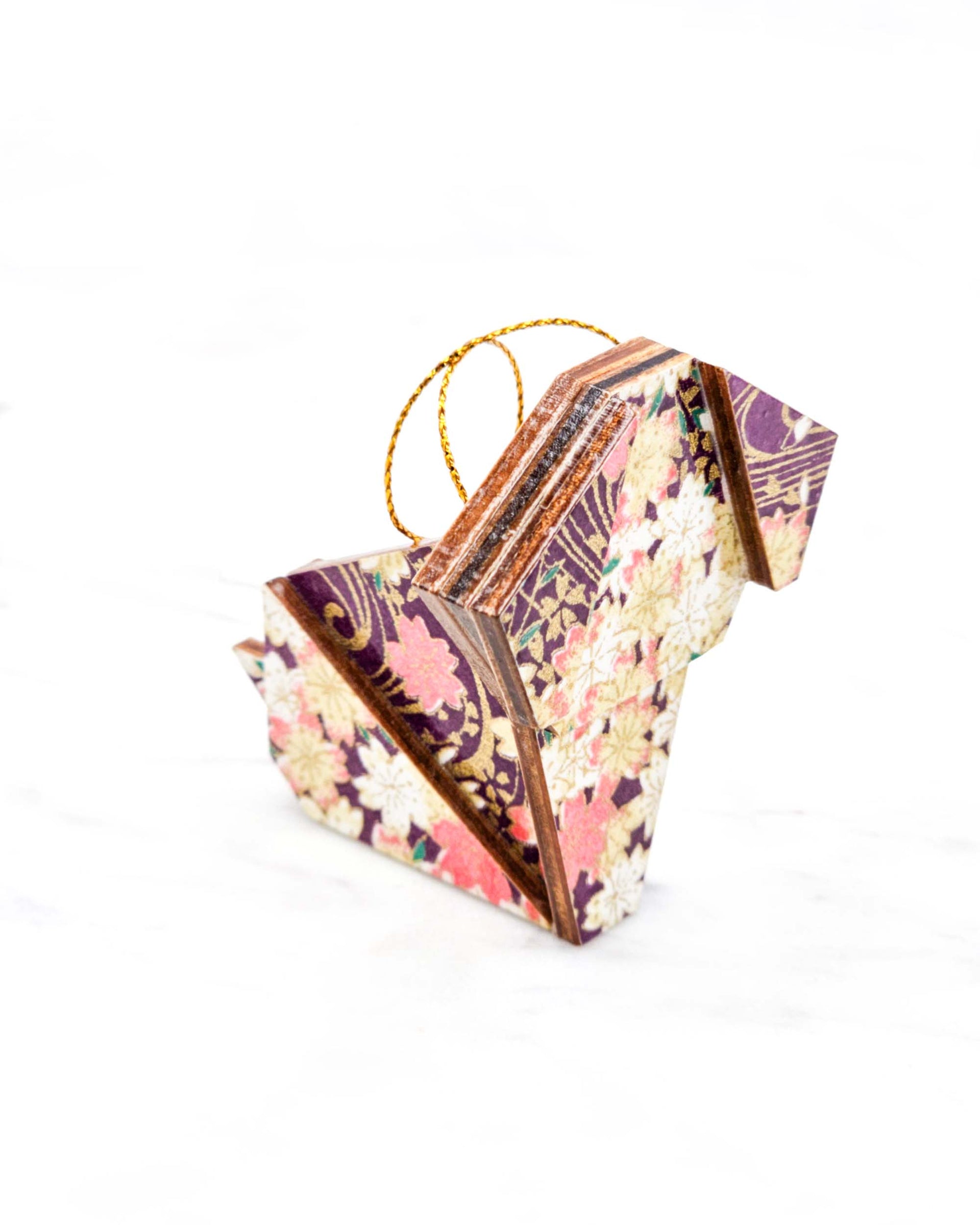 Small wooden origami dog ornament featuring pink and cream cherry blossoms on a dark purple background with metallic gold details.