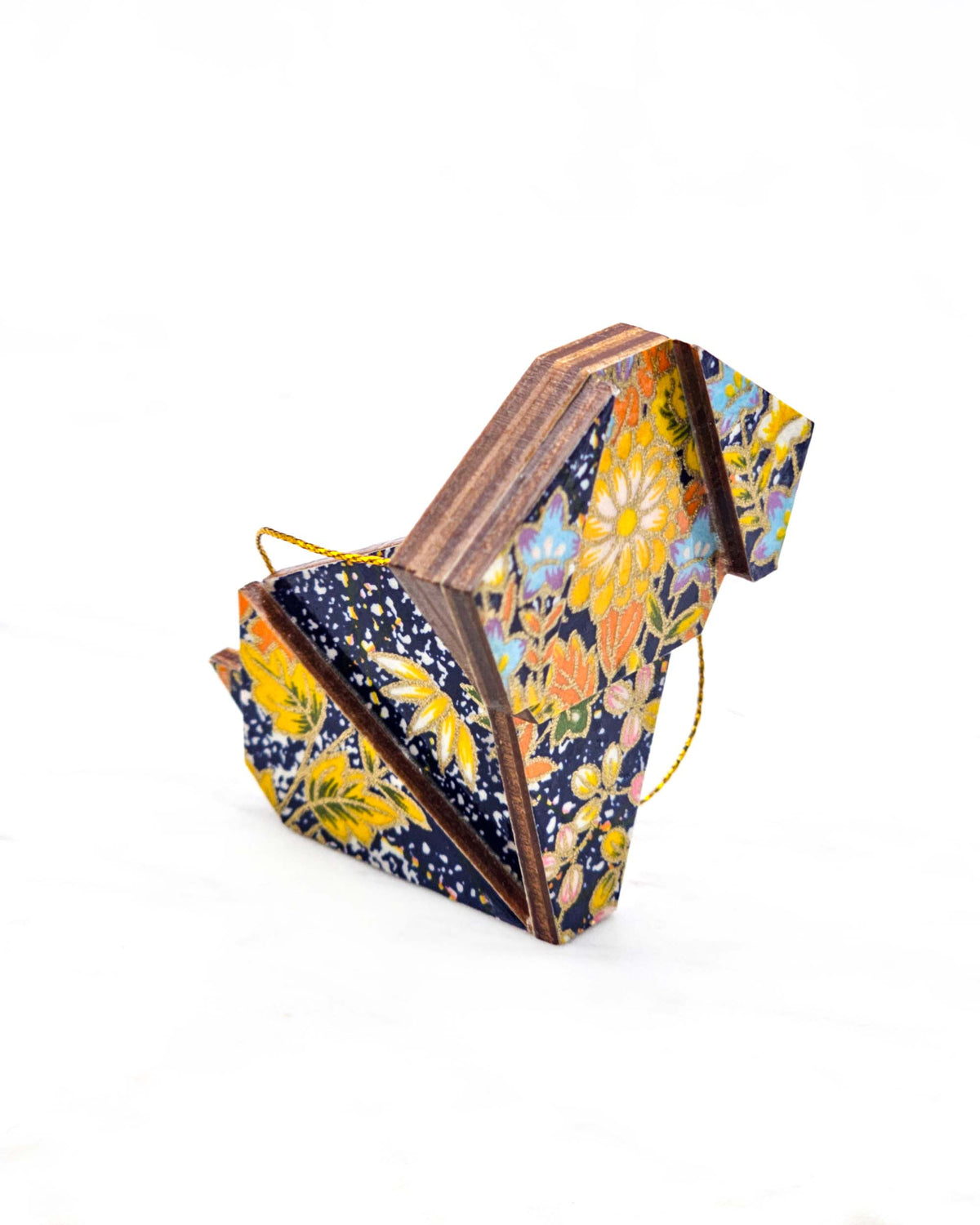 Small wooden origami dog ornament featuring an assortment of blue, yellow, orange, and green flowers on a dark blue background with metallic gold details.