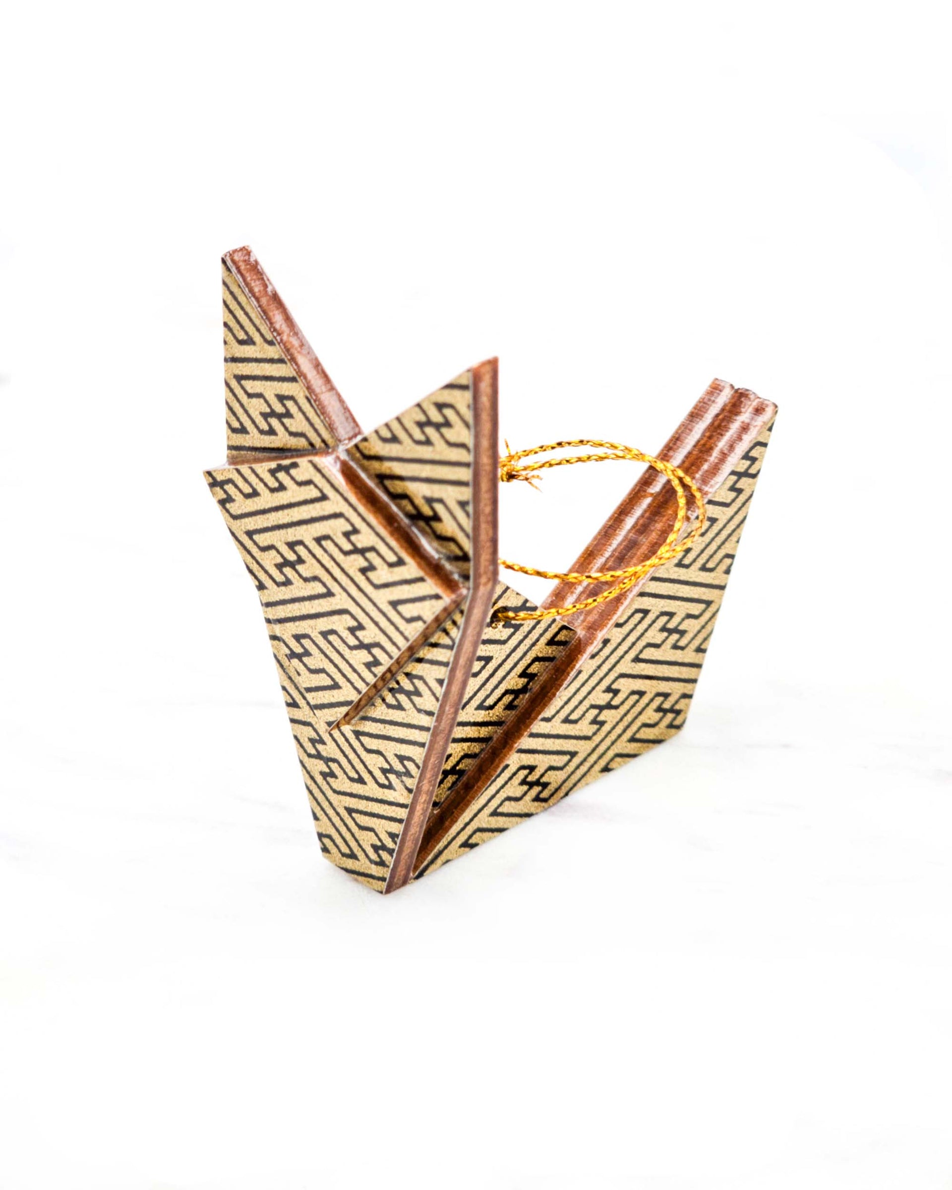 Small wooden origami fox ornament featuring a black traditional Japanese sayagata pattern on a metallic gold background.