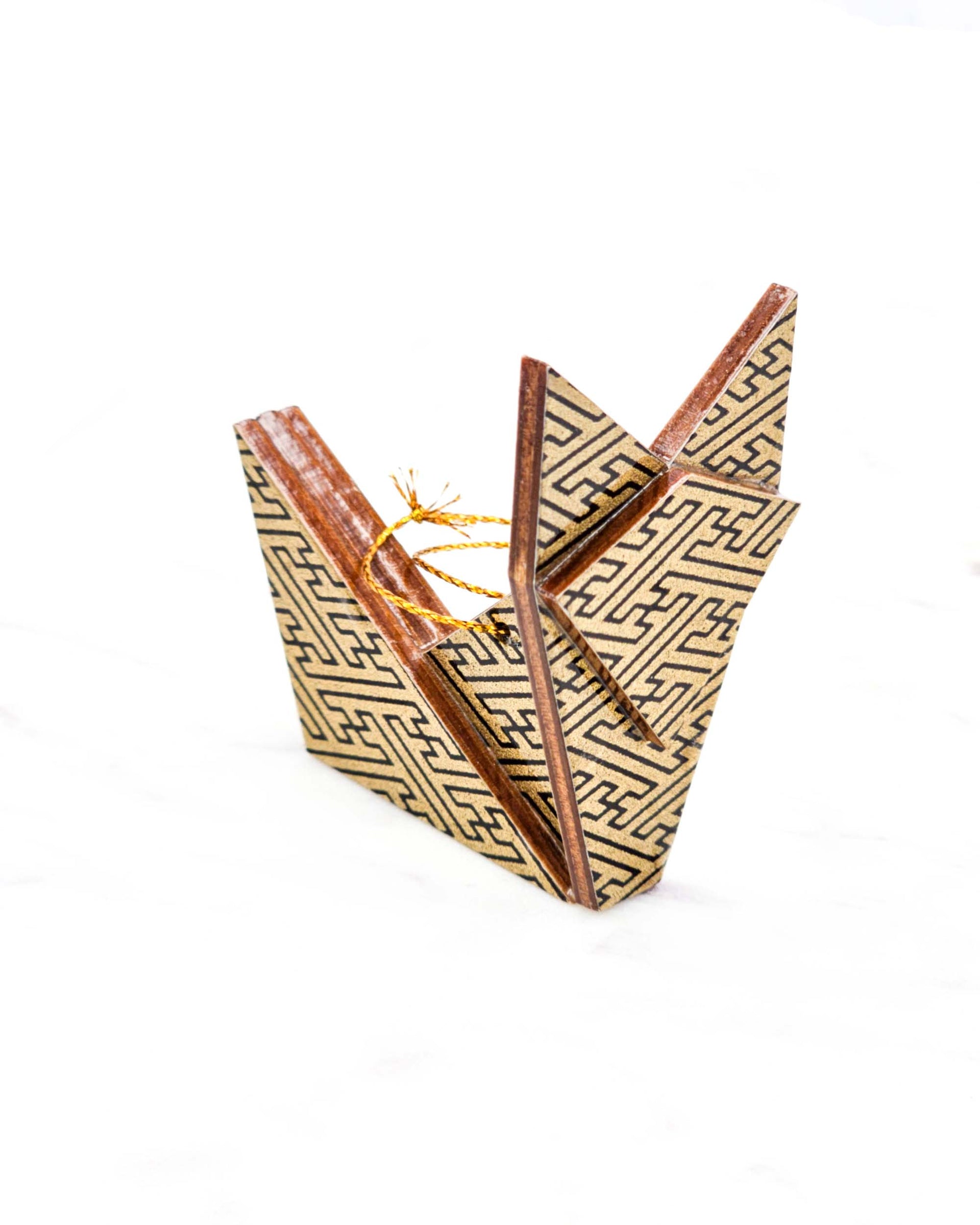 Small wooden origami fox ornament featuring a black traditional Japanese sayagata pattern on a metallic gold background.